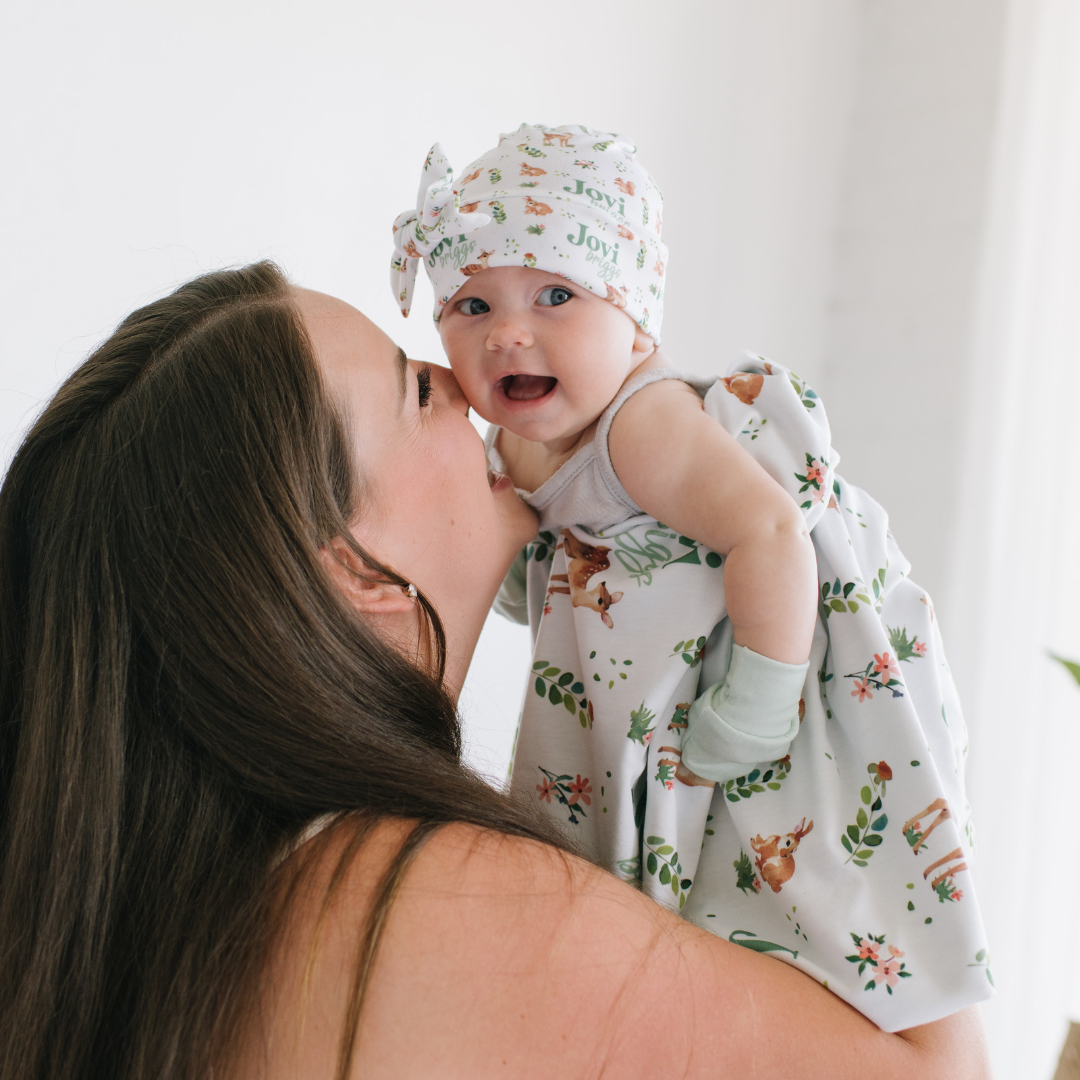 Mom holding up her baby and laughing together
