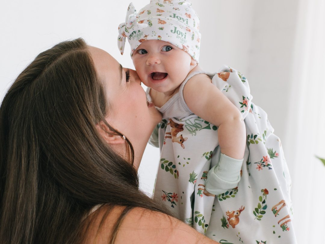Mom holding up her baby and laughing together